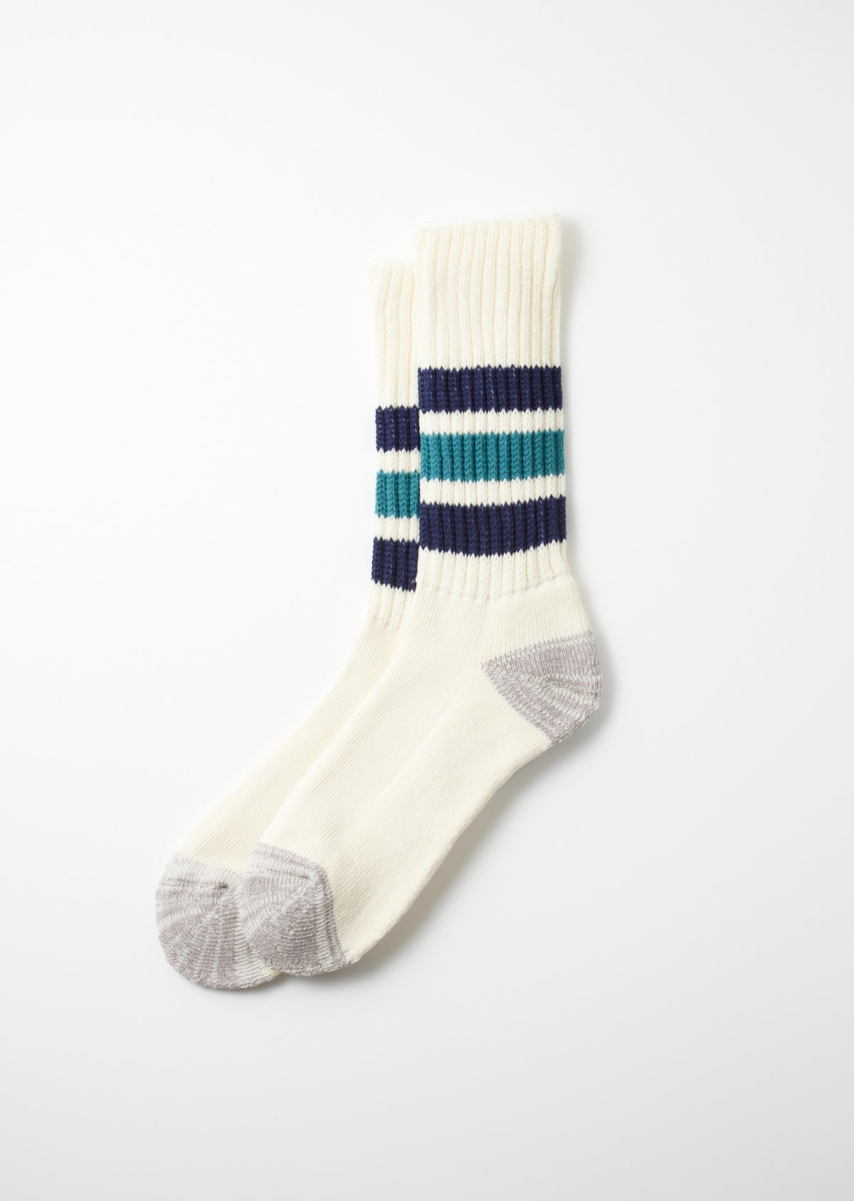 Pair of cream coarse ribbed old school crew socks with dark blue and teal stripes and grey heels and toes.