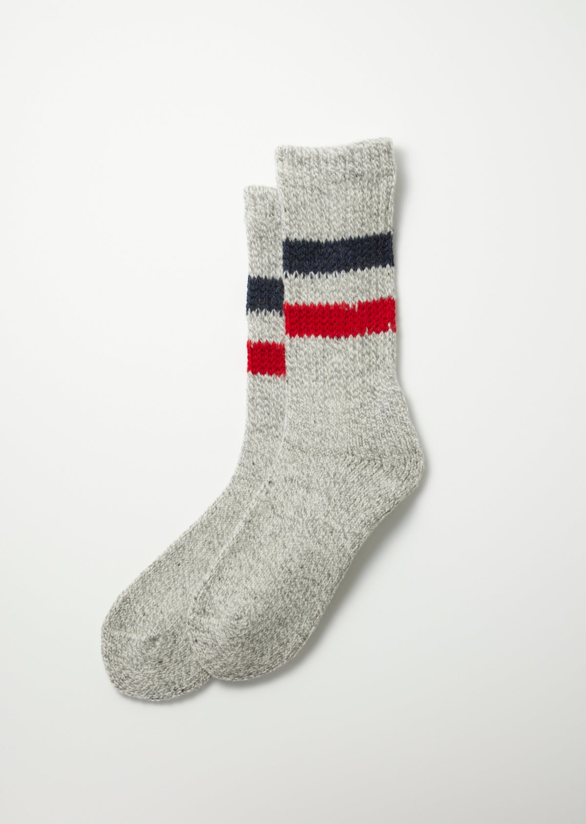A pair of heather grey knitted socks with navy and red retro stripes.