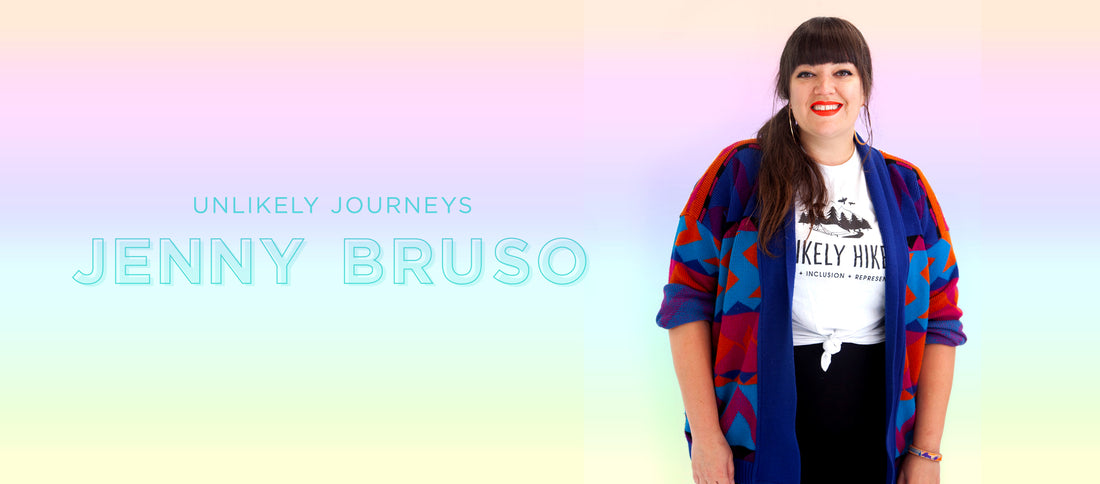 Jenny Bruso smiles brightly in a colorful cardigan, standing against a soft rainbow gradient, embodying inclusion and adventure.