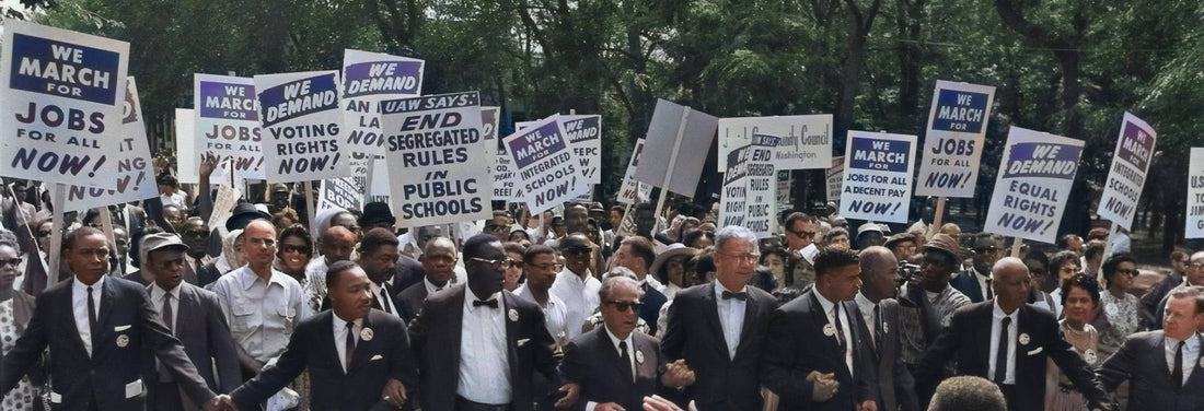 Crowd marches for civil rights, holding signs demanding jobs, voting rights, and desegregation.