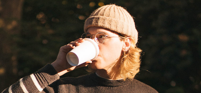 Cozy beige knit beanie, warm sunlight, relaxed outdoor moment, soft textures, everyday style.