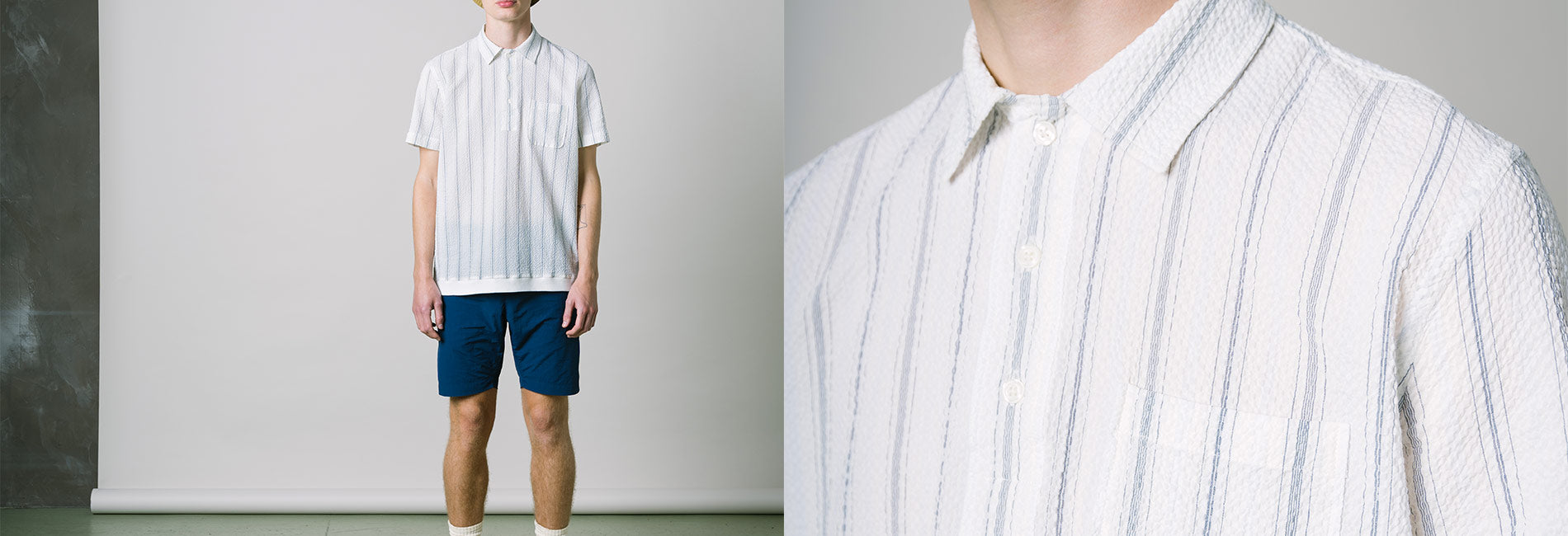 SS21 Collection: crisp white striped shirt with blue shorts, minimalist summer style, textured fabric, clean lines, relaxed fit.