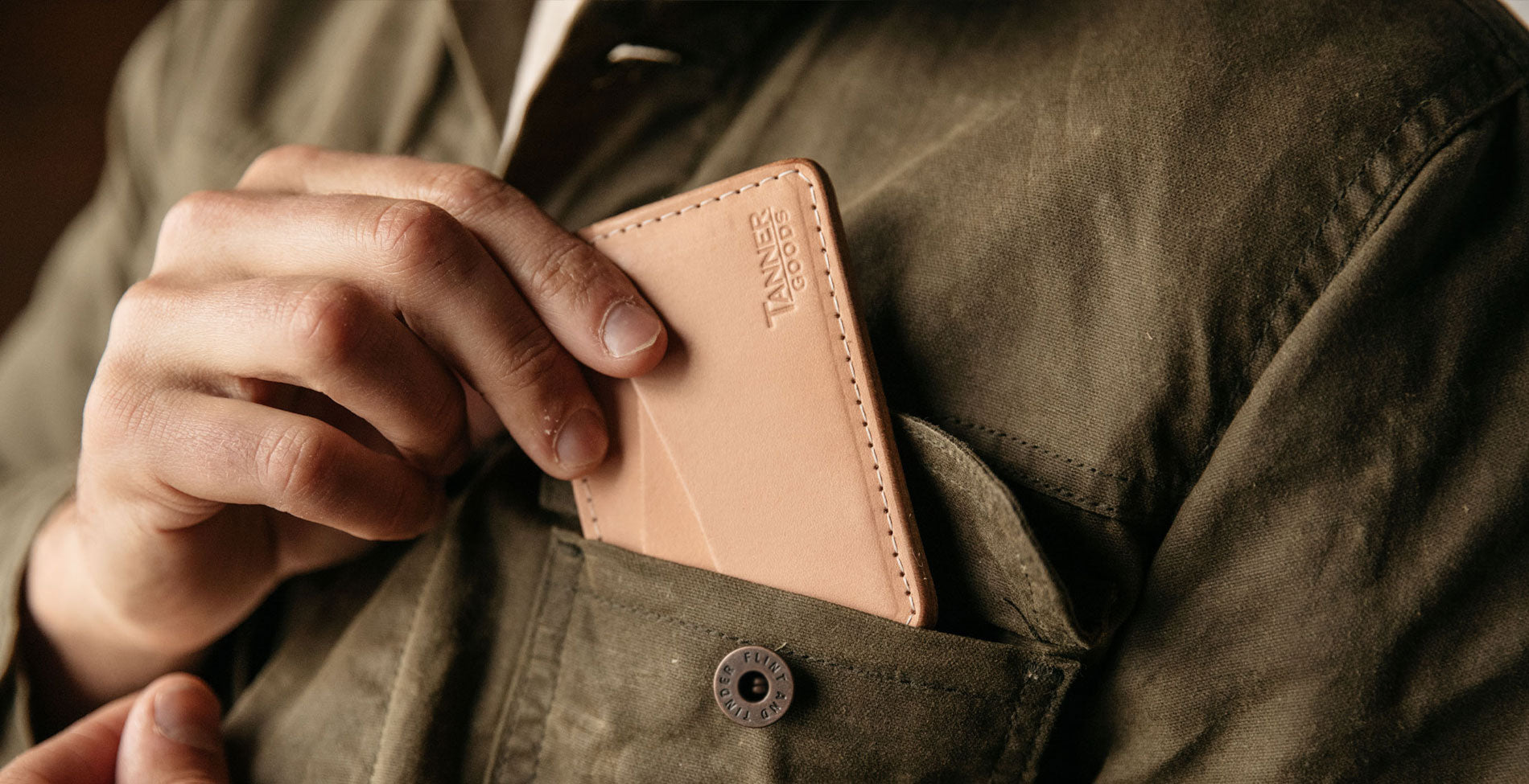 Tan leather Tanner Goods wallet in olive jacket pocket, rugged style, Father’s Day gift under $100