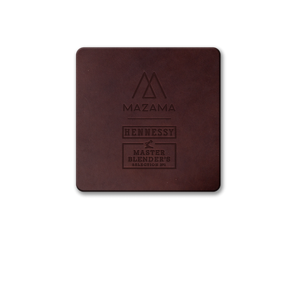 A square, dark brown leather coaster with embossed Mazama, Hennessy, and Master Blender's Selection N°1 text.