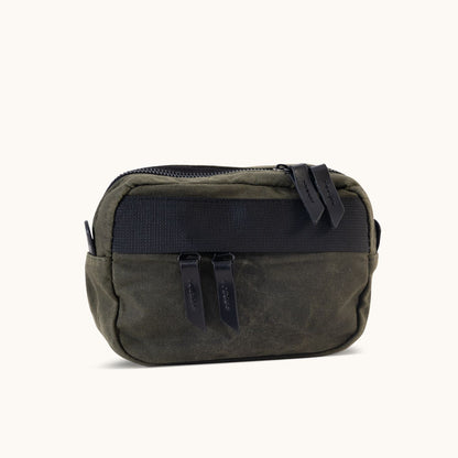 Juniper Green Waxed Canvas Canyon Crossbody Mini with black zipper and pulls on a white background.
