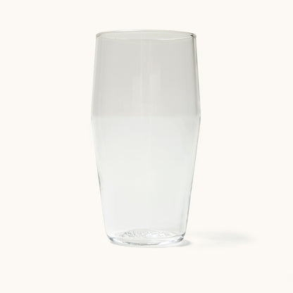 Clear standard pint glass with tapered shape and textured base, front view on white background