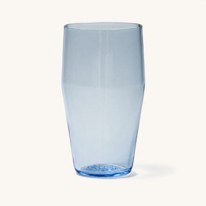 Clear standard pint glass with subtle blue tint and embossed base, front view on white background