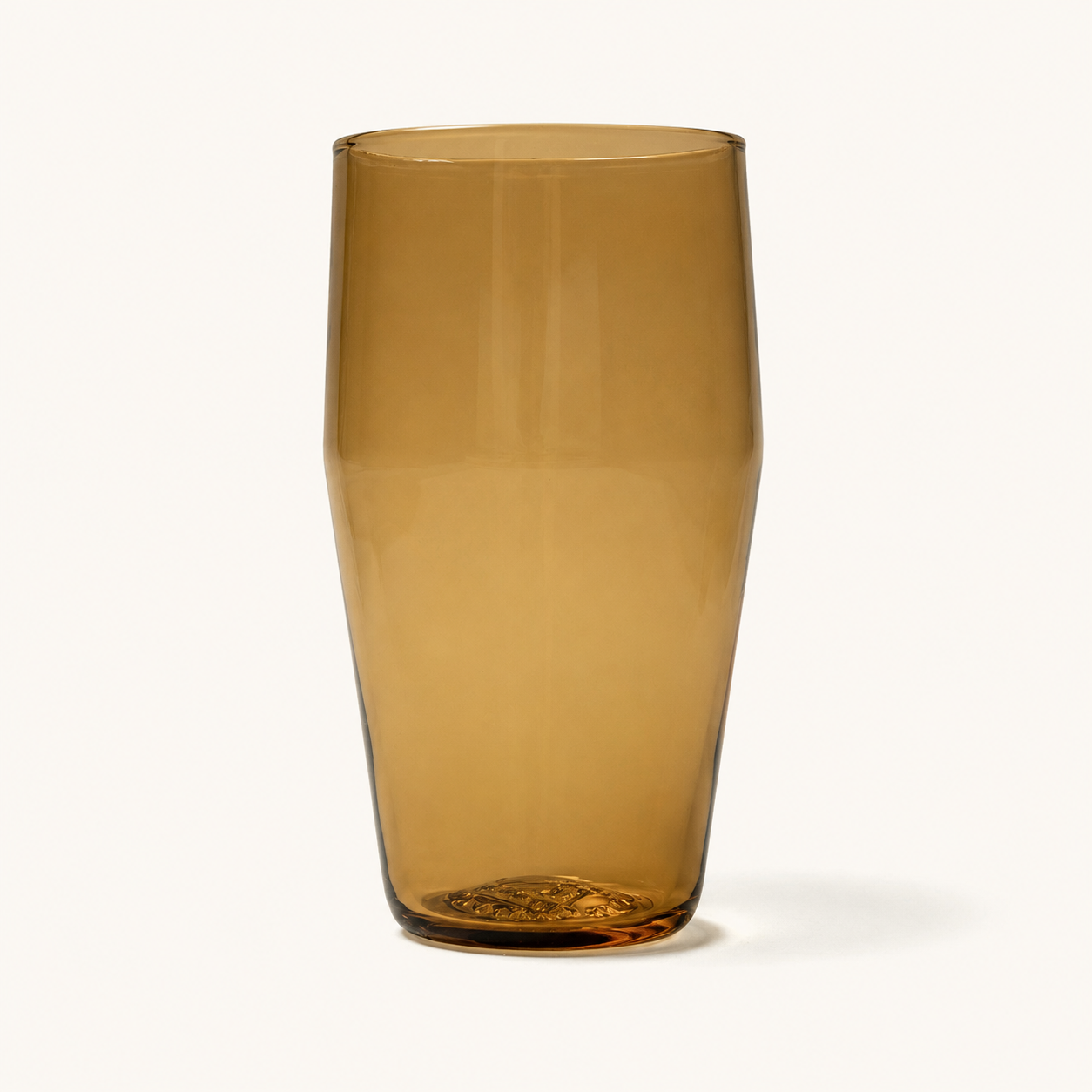 Amber tinted standard pint glass with textured base, front view, clear glass material, smooth finish