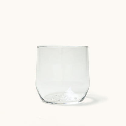Clear glass cocktail glass with a stemless design, rounded bottom, and slight taper.