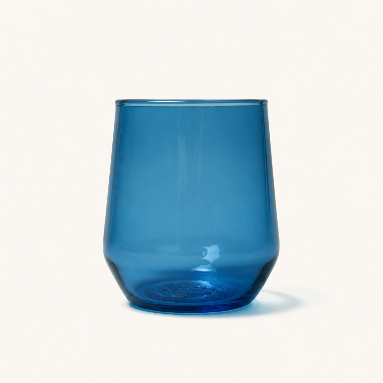 Blue stemless wine glass with embossed base design, front view, clear glass material