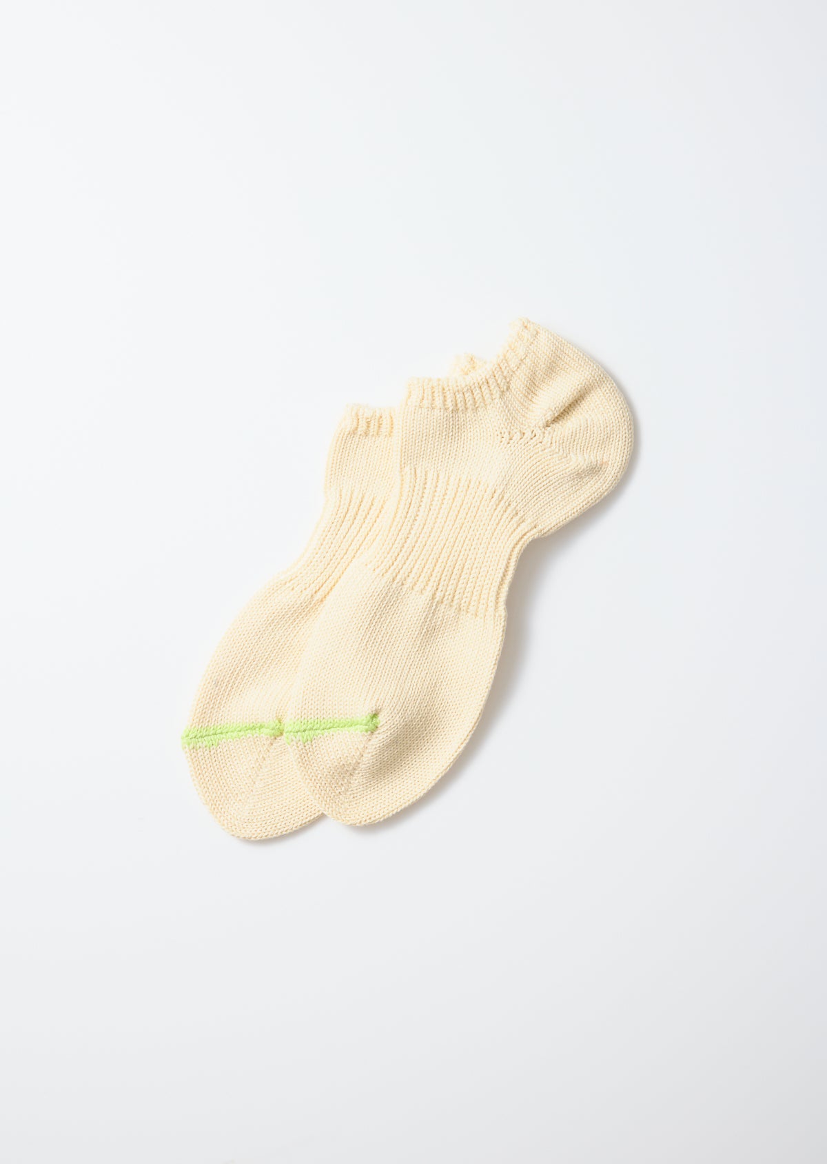 Cream chunky sneaker socks with a lime green stripe across the toes, laid flat.