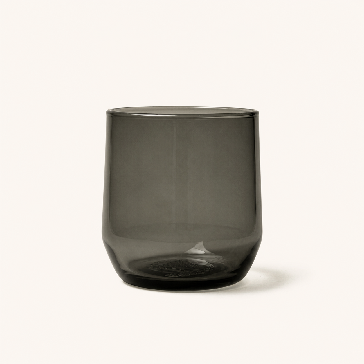 Smoky gray cocktail glass with rounded shape and embossed base, front view, clear glassware design
