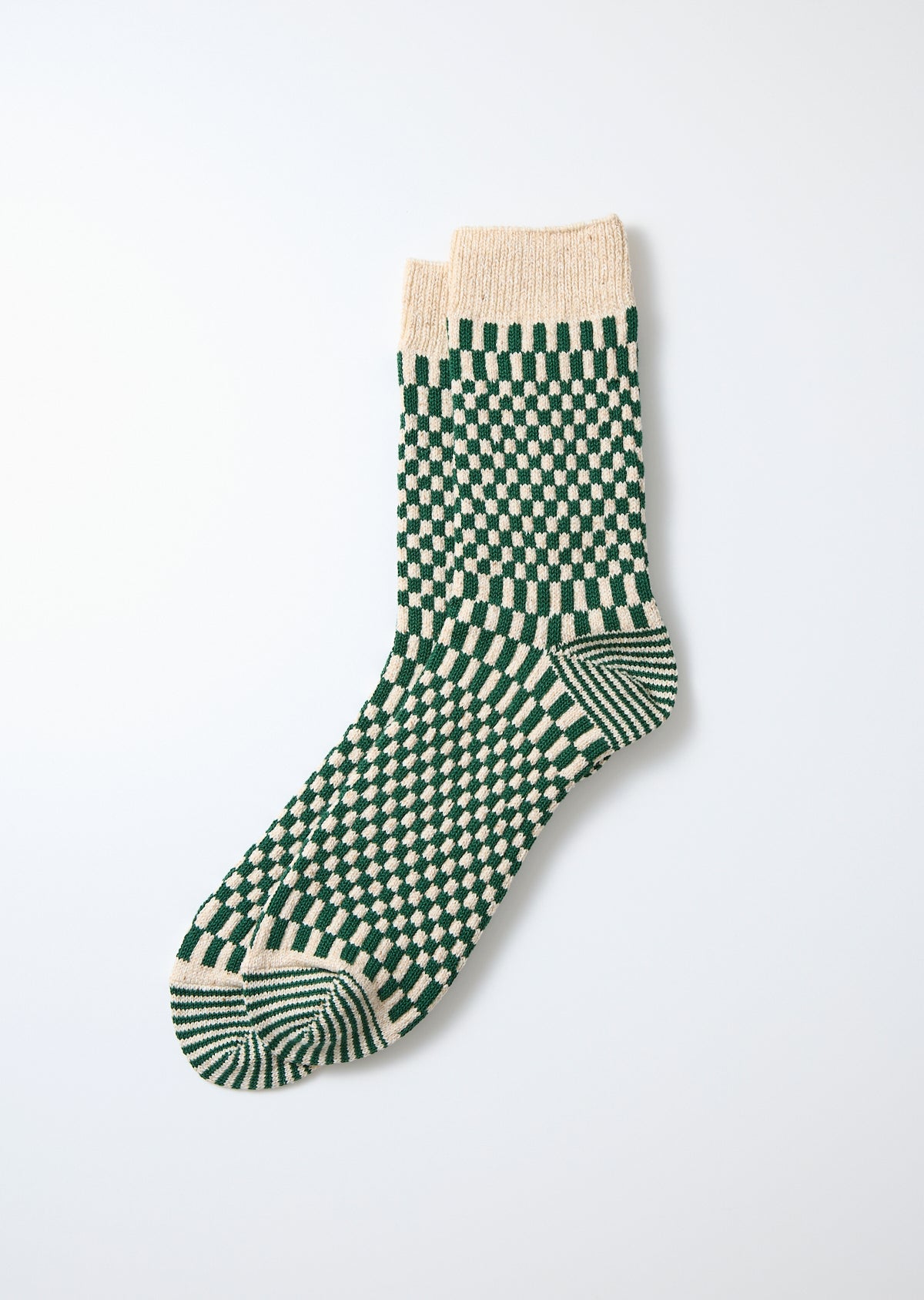 Green and cream checkerboard pattern crew socks with a ribbed cuff.