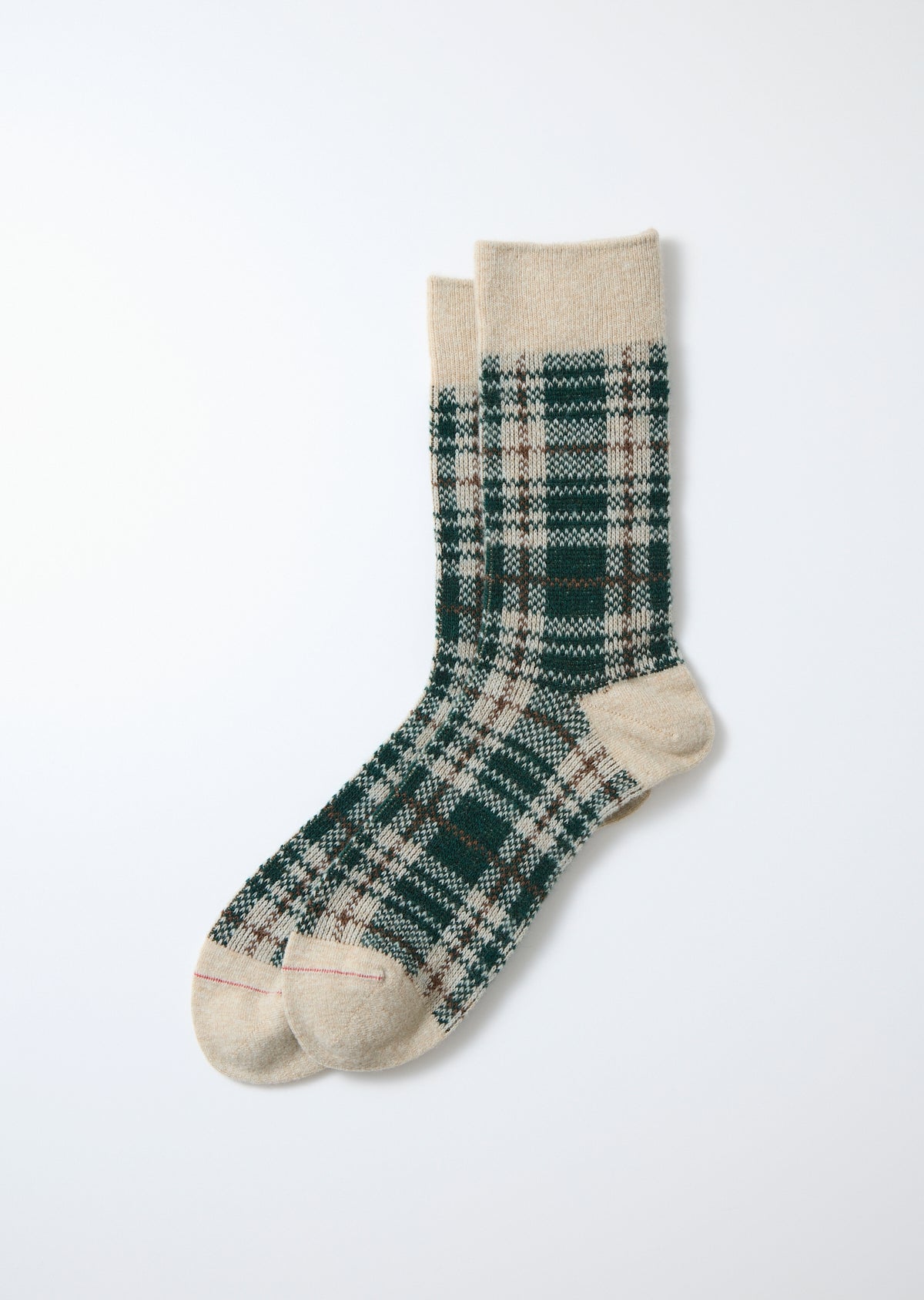 Merino socks with a green, brown, and cream check pattern, featuring solid beige cuffs and toes, laid flat.