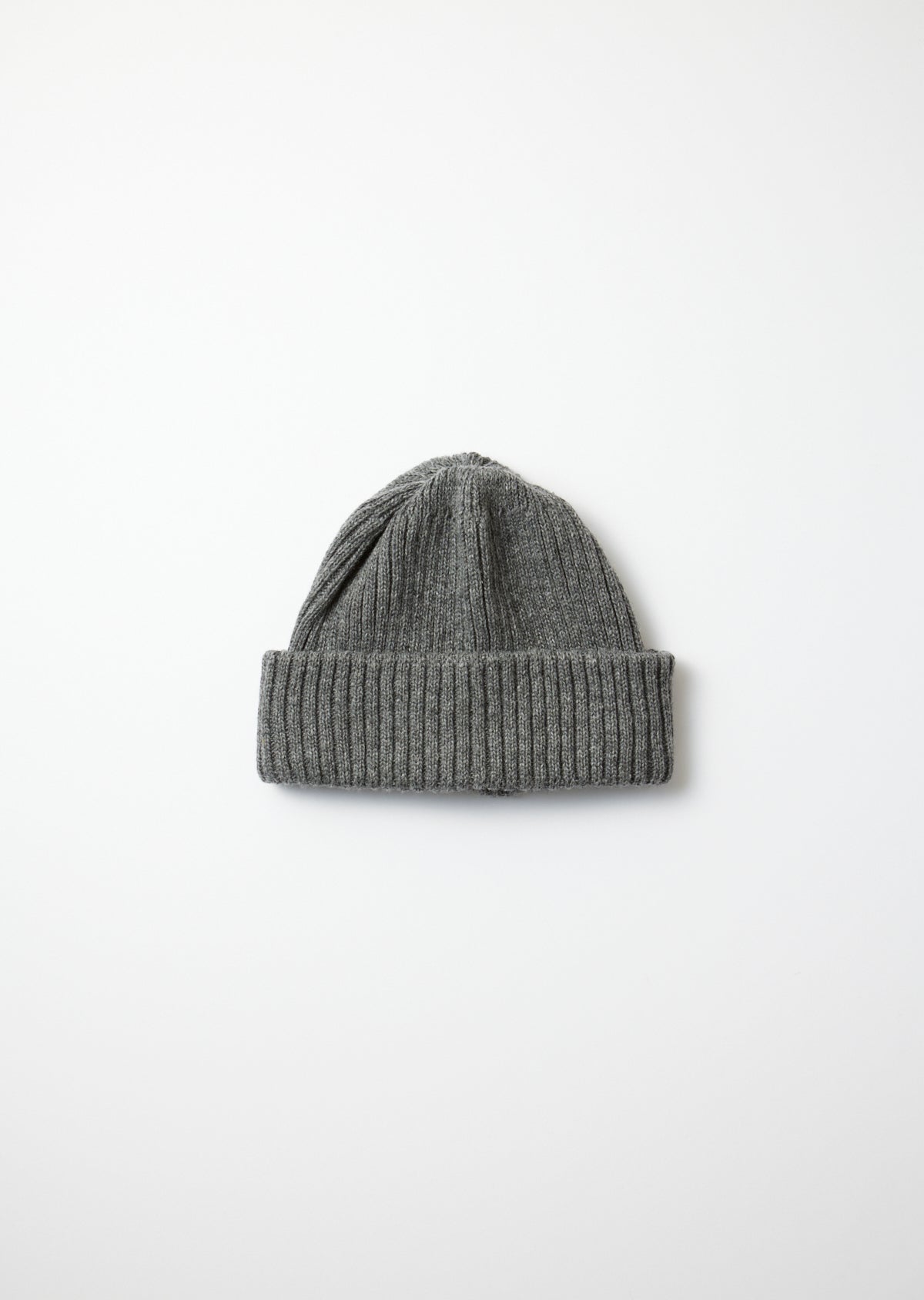 Dark gray recycled wool beanie with a ribbed folded brim and knitted texture, flat lay on white.