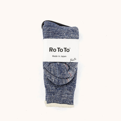 Deep Ocean Double Face Crew Socks by Ro To To, folded with a mottled blue-grey texture and creamy white interior cuff.