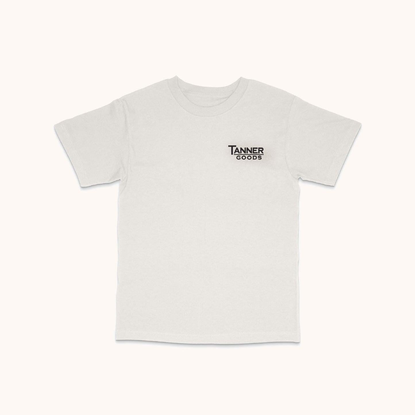 White short-sleeved T-shirt with a small black "Tanner Goods" logo on the left chest, laid flat.