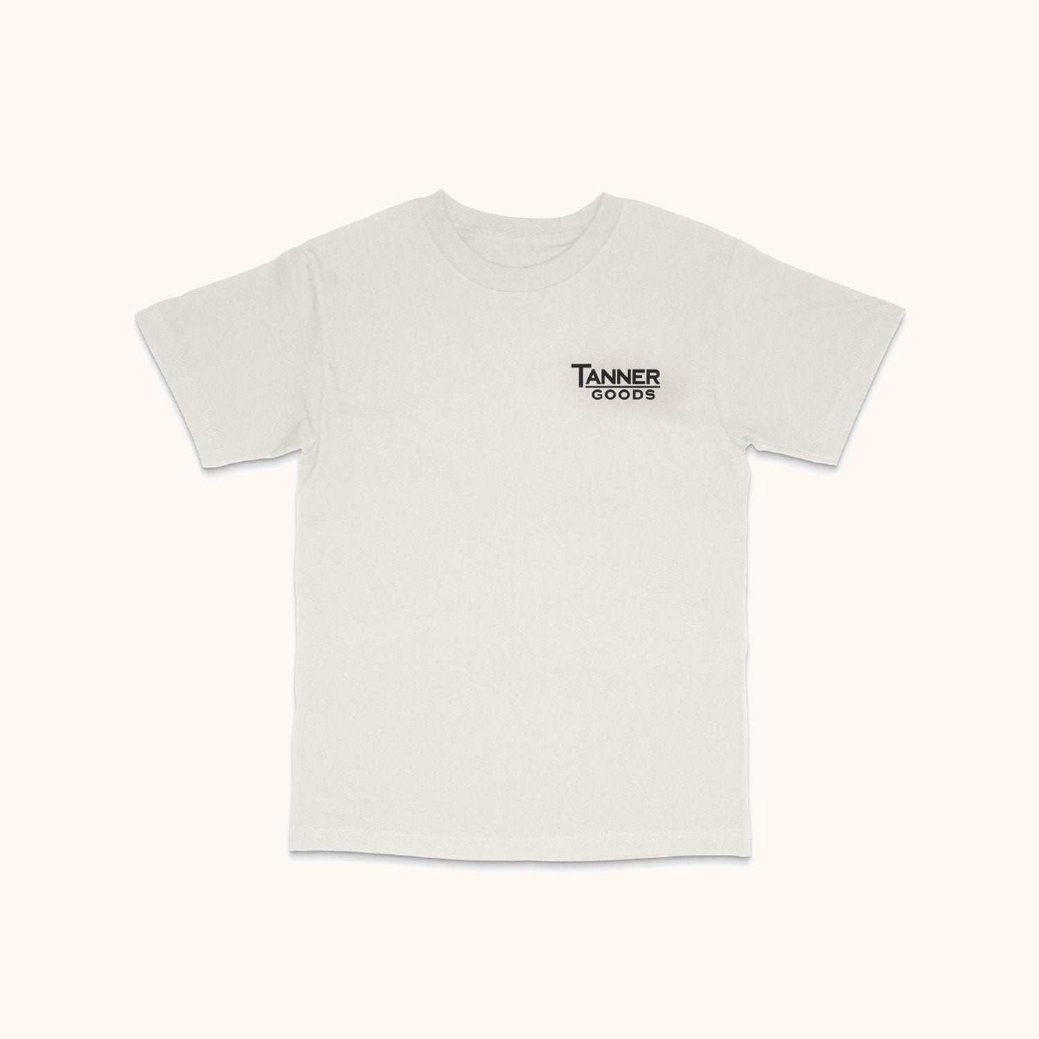 White short-sleeved T-shirt with a small black "Tanner Goods" logo on the left chest, laid flat.