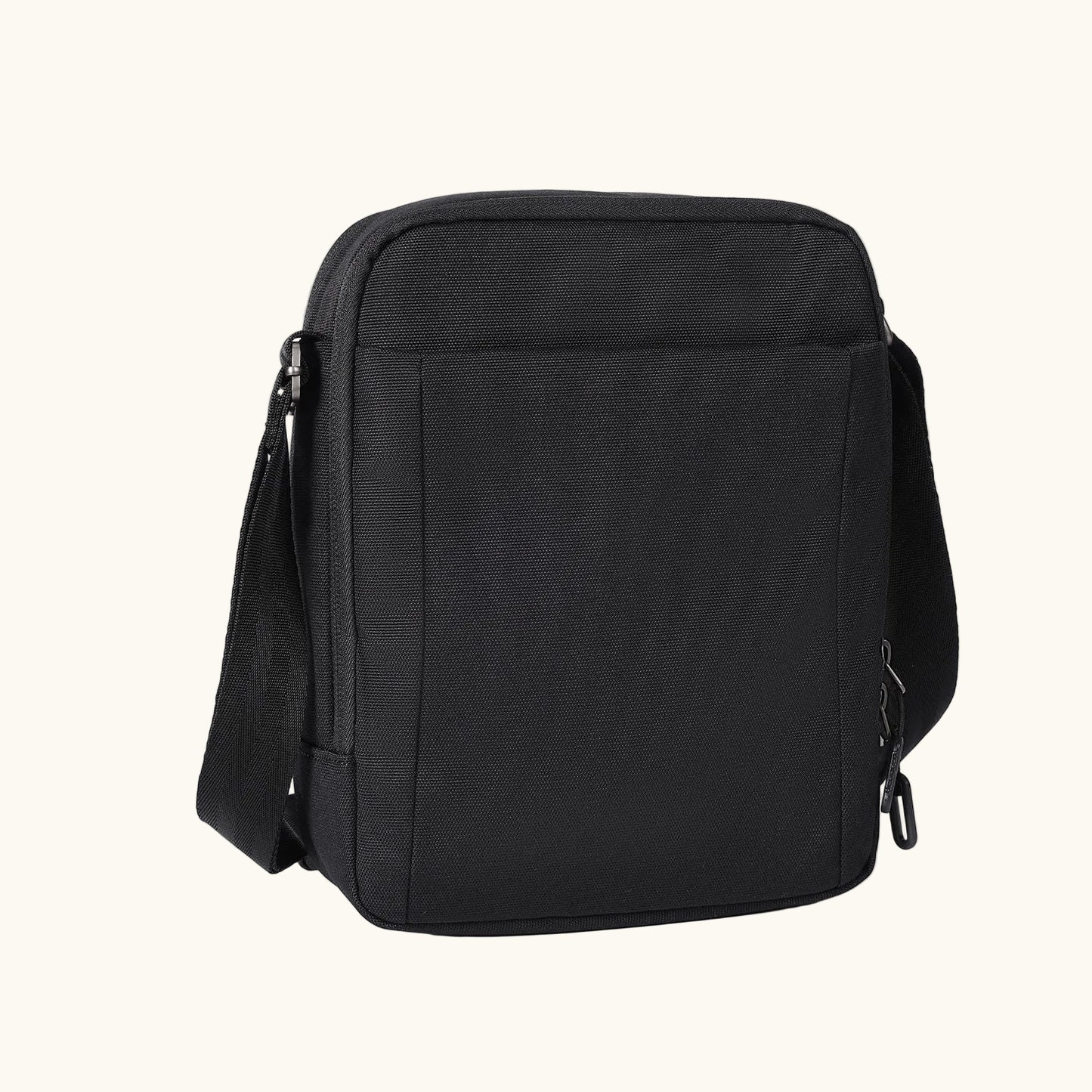Black woven fabric sling bag by Hedgren, with a zippered back pocket, adjustable strap, and a carabiner clip.