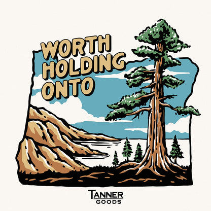 T-shirt by Tanner Goods featuring a vintage outdoor graphic with a large tree, mountains, and lake, alongside text 'WORTH HOLDING ONTO'.