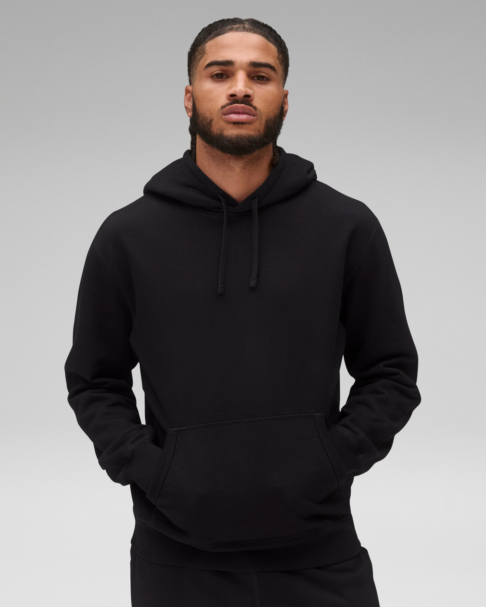 Black Midweight Terry Standard Hoodie with drawstrings and a front kangaroo pocket, worn by a man.