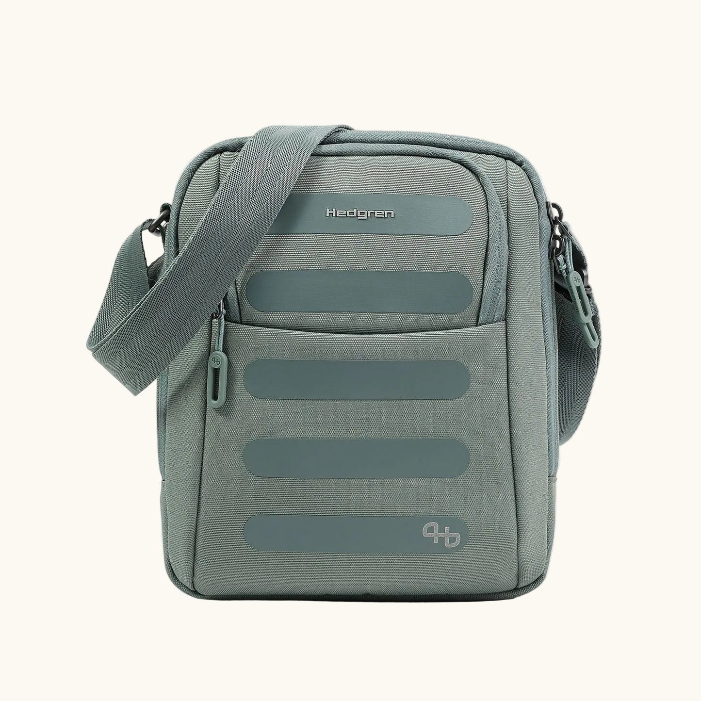 A gray-green sling bag by Hedgren, with a ribbed texture, smooth horizontal accents, and an adjustable strap.