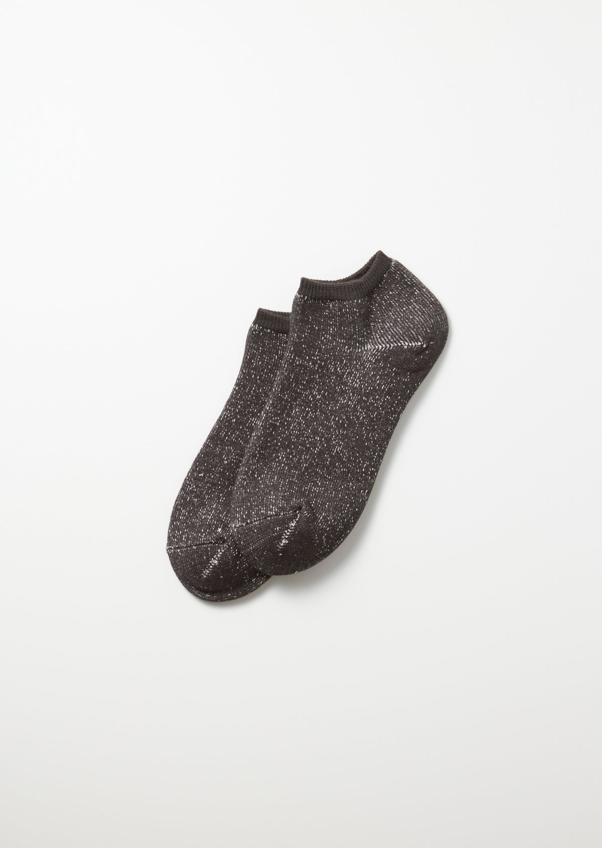 A pair of charcoal Washi Pile short socks, speckled with white flecks, angled on a white background.