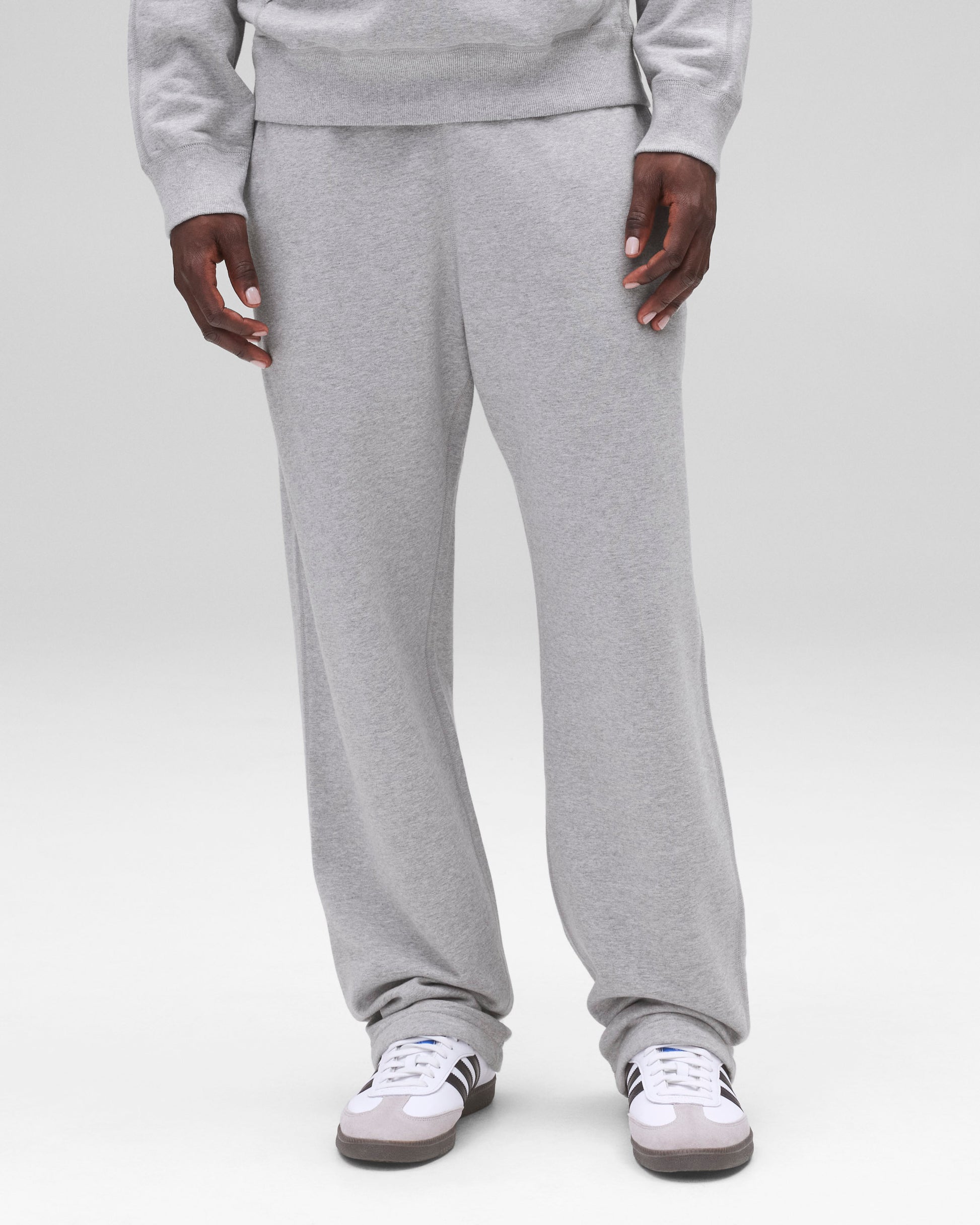 Relaxed Midweight Terry Sweatpant in grey, styled with wide legs pooling over white sneakers.