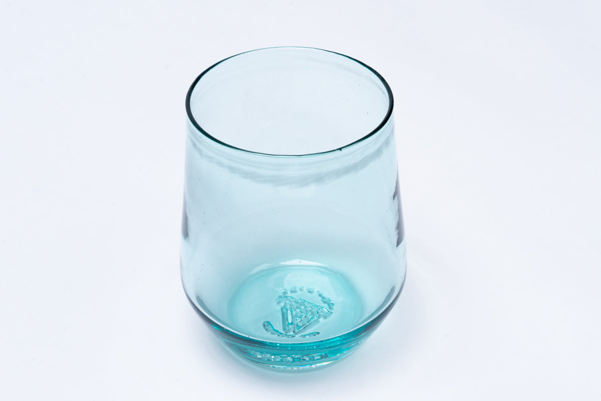 Light blue stemless wine glass with an embossed crown-like symbol on the bottom.