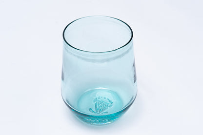 Light blue stemless wine glass with an embossed crown-like symbol on the bottom.