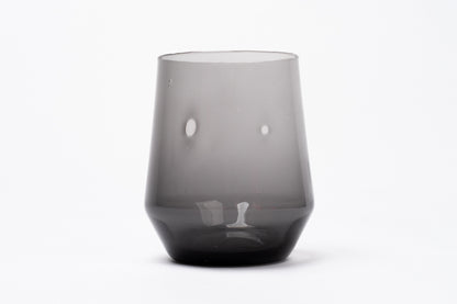 Smoky dark gray glass wine glass with a conical shape, wider top, and thick base.