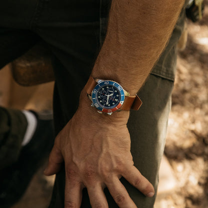 Cordovan leather Nato watch strap in natural color by, worn on wrist with blue dial watch, side view, textured surface, lifestyle shot