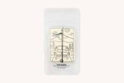 Off-white air freshener by Tanner Goods featuring a line art mountain and car scene labeled 'HIGH SABAKU', inside clear packaging.