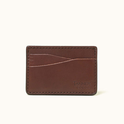 Cognac leather wallet by Tanner Goods with multiple card slots, visible stitching, and embossed logo.