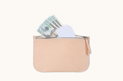 Natural leather universal zip pouch with a zipper, holding play money and white cards.
