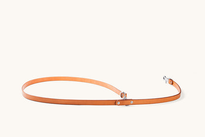 Saddle Tan leather convertible canine lead with silver-toned hardware, laid out on a light background.