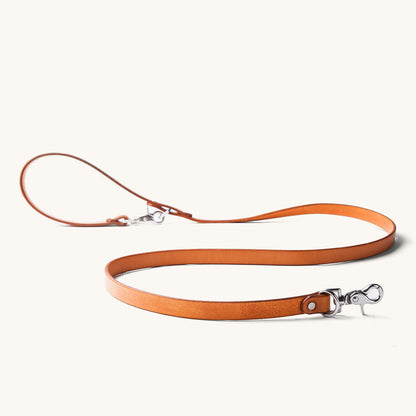 Saddle Tan leather convertible canine lead with two silver-toned clasps.