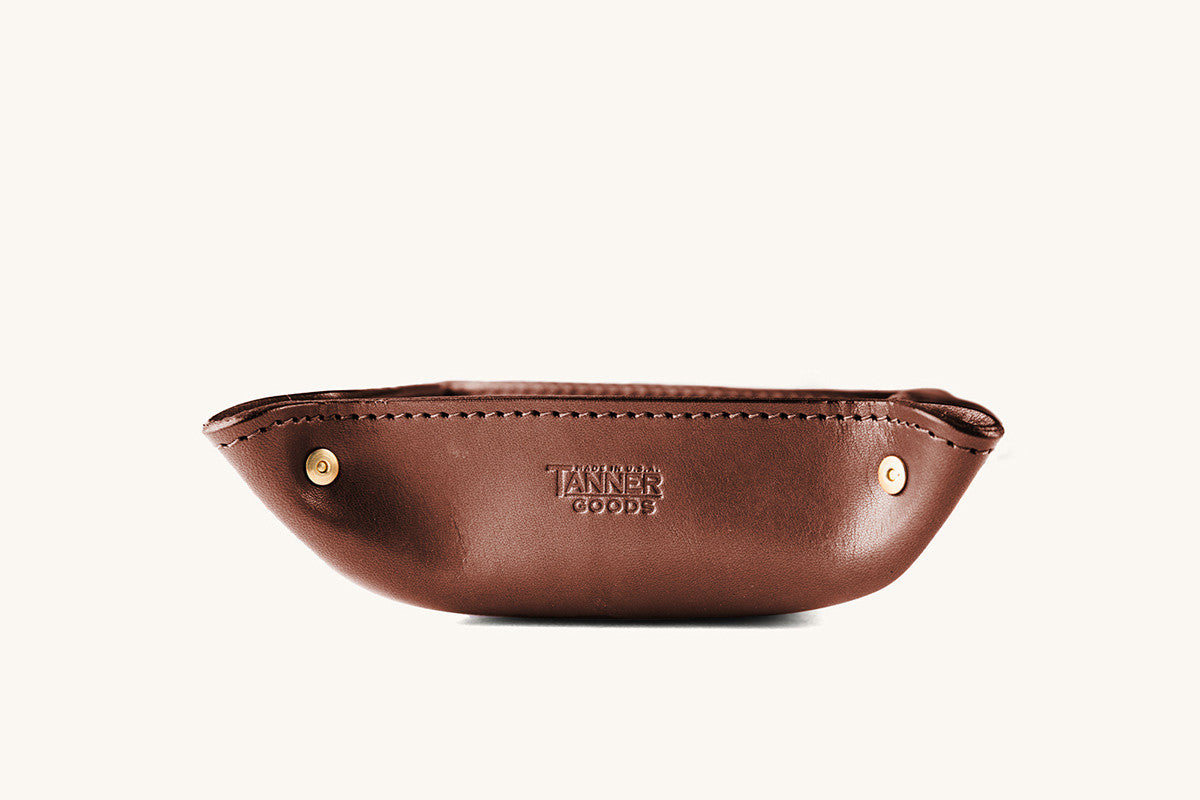 Cognac leather valet tray by Tanner Goods with stitched edges, brass rivets, and embossed logo, front view.