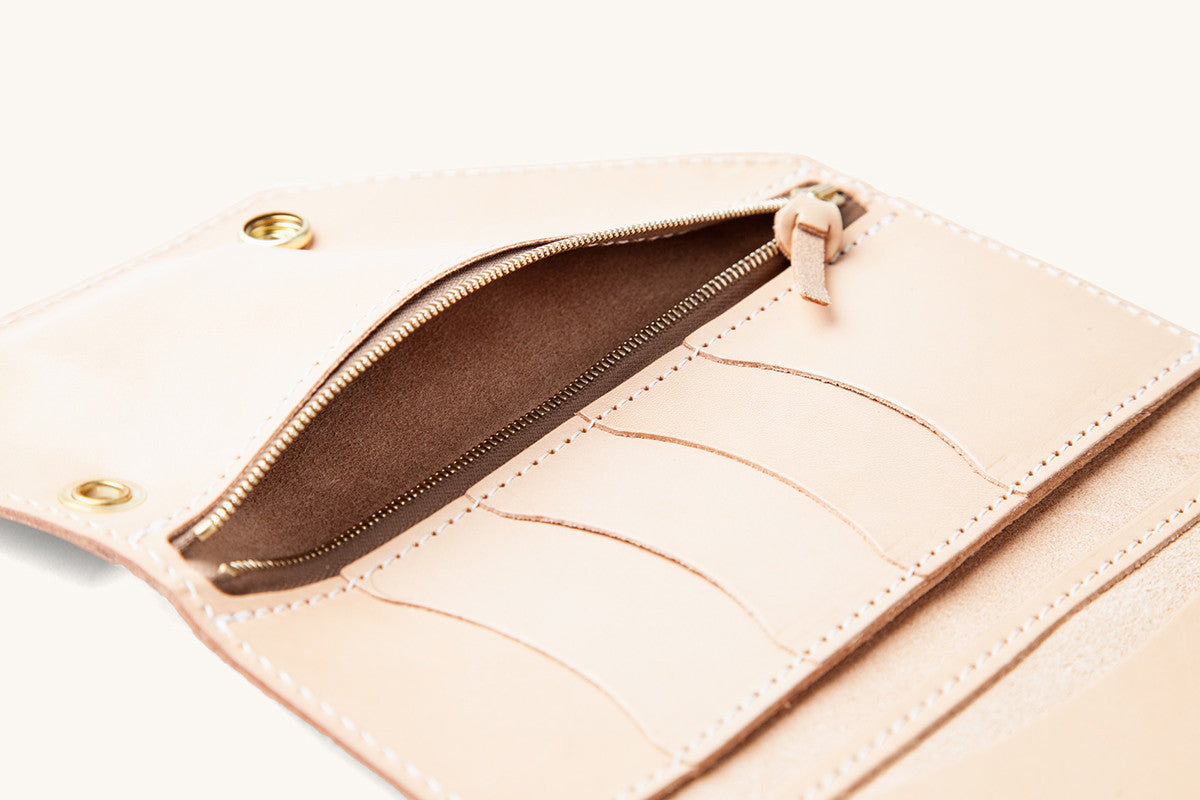 Natural leather Workman Wallet open, displaying an interior zipper pocket, multiple card slots, and brass grommets.